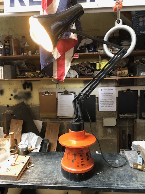 Angle-poise light on industrial pattern base.