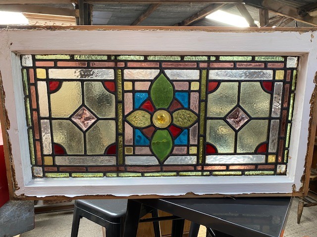 Leaded glass panel in wooden frame.
