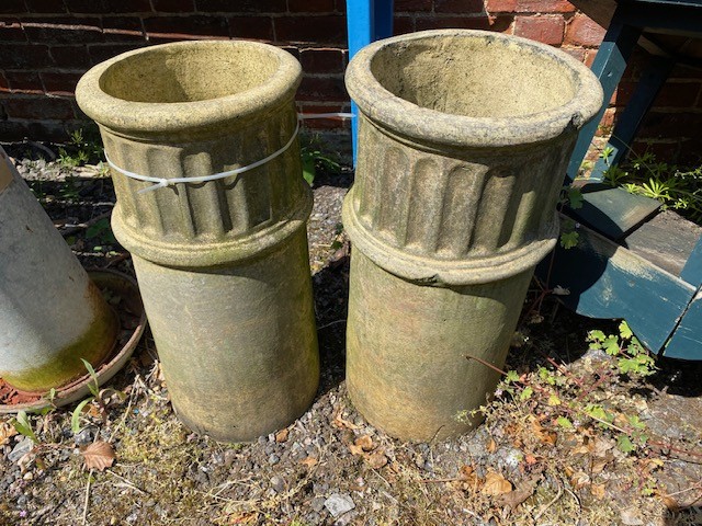 Pair of buff round chimney pots with decorative channeling